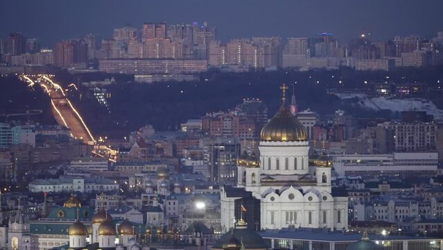 The famous symbol of Moscow, the Cathedral of Christ the Saviour, at night against the background of the cityscape. The famous establishing plan of the Cathedral of Christ the Saviour