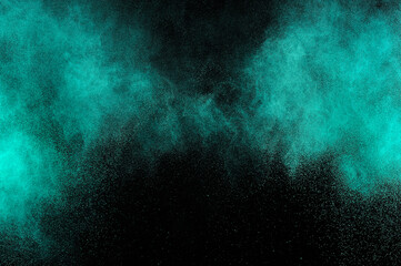 Aquamarine powder explosion on black background. Colored powder cloud. Colorful dust explode. Freeze motion paint  Holi.