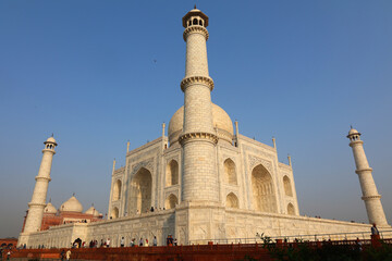 The Taj Mahal at sunrise is an ivory-white marble mausoleum on the right bank of the river Yamuna in Agra 