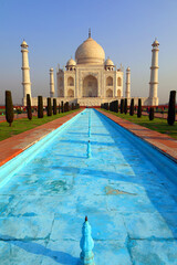 The Taj Mahal at sunrise is an ivory-white marble mausoleum on the right bank of the river Yamuna...