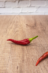 very spicy red and green chilly pepper, seasoning ingredient, on wooden board