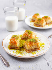 Turkish-style pistachio baklava with a glass of milk.