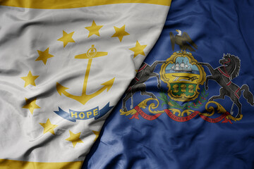 big waving colorful national flag of pennsylvania state and flag of rhode island state .