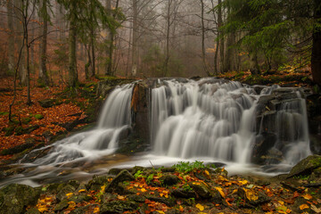 Fototapeta na wymiar Ponikly waterfall with flood water after night rain in autumn morning