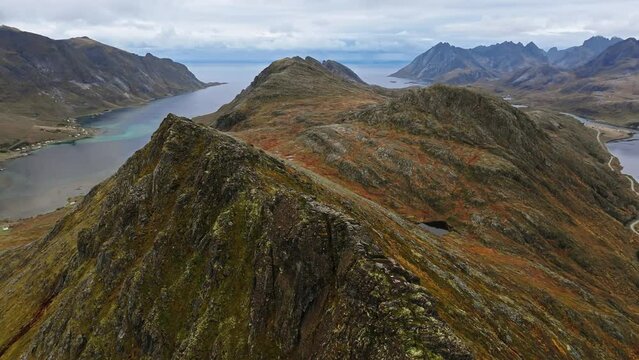 Aerial Glimpse from a Hill, Displaying the Ocean and Majestic Mountain Peaks of Lofoten, Norway
