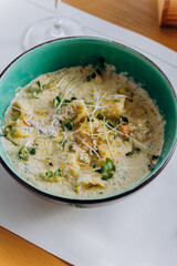 Tasty Mussels in cheese sauce with dumplings served with greens. Restaurant menu