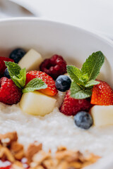 Sweet milk semolina porridge with strawberries on beautiful plate. Delicious breakfast for children