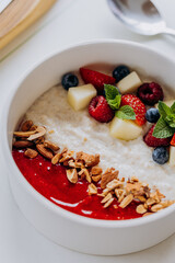 Sweet milk semolina porridge with strawberries on beautiful plate. Delicious breakfast for children