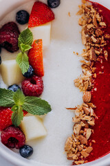 Sweet milk semolina porridge with strawberries on beautiful plate. Delicious breakfast for children