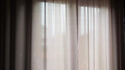 Side view smiling dreamy woman opening curtains in early morning, looking out window in distance, thinking and dreaming, happy beautiful young female feeling positive, starting new day