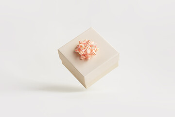 white gift box floating in the air on a white background. Mother's Day, Valentine's Day, Christmas and New Year gifts concept