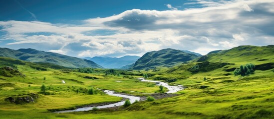 The background of the summer landscape in Scotland s highland offers a breathtaking view of the green mountains against the blue sky