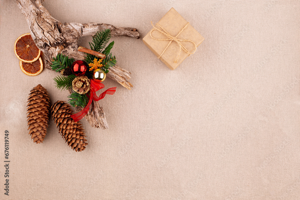 Wall mural christmas holiday background with fir tree decorated with pine cone, cinnamon sticks and gift wrappe