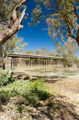 The Darling River in outback Australia with a highway crossing the bridge above it
