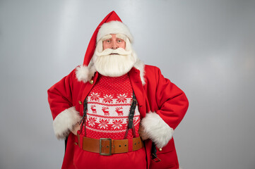 Portrait of an elderly man in a santa claus costume on a white background. 