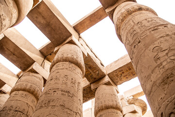 ancient Egyptian hieroglyphs on massive columns of hippostyle hall in karnak temple in luxor, egypt - obrazy, fototapety, plakaty