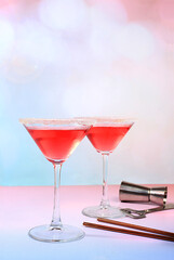 Festive alcoholic cocktail with red martini, lemonade, champagne in glasses on a bright background, bar concept, alcoholic drinks at a party, advertising for a restaurant,