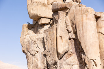 Massive ruined stone Pharaoh statues at Colossi of Memnon in Luxor, Egypt