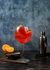 Festive alcoholic cocktail Aperol spritz in glasses on a dark background, concept for bar and New Year's Eve, alcoholic drinks at a party, advertising for a restaurant,
