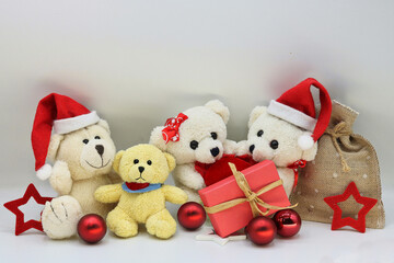 Christmas card with a family of teddy bears with Christmas decoration on a white background