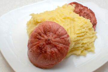 Mashed potatoes with fried sausage