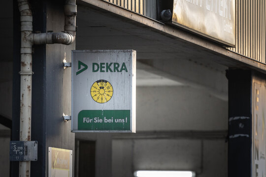 COLOGNE, GERMANY - NOVEMBER 11, 2022: Logo of Dekra in front of one of their offices. Dekra is a German chain specialized in technical and motor inspection for cars and other vehicles.