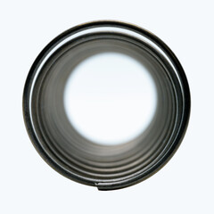 An isolated macro view of the tubular center of a spring resembling a fictitious swirling time portal to infinity
