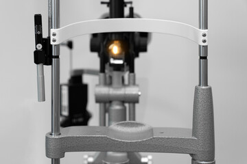 ophthalmic equipment placed in light contemporary optical shop for checking vision, slit lamp...
