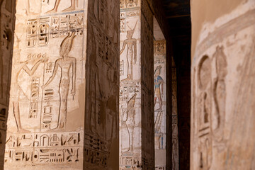 large colorful hieroglyphs on columns in ancient egyptian temple in luxor, egypt