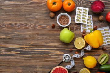 Composition with different healthy products, pills and measuring tape on wooden background