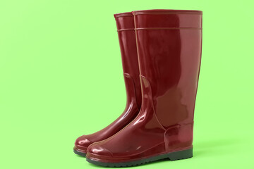 Red gumboots on green background