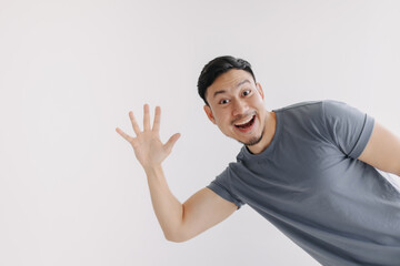 Happy asian man pop out for greeting and say hi, stand isolated on white. © Sevendeman
