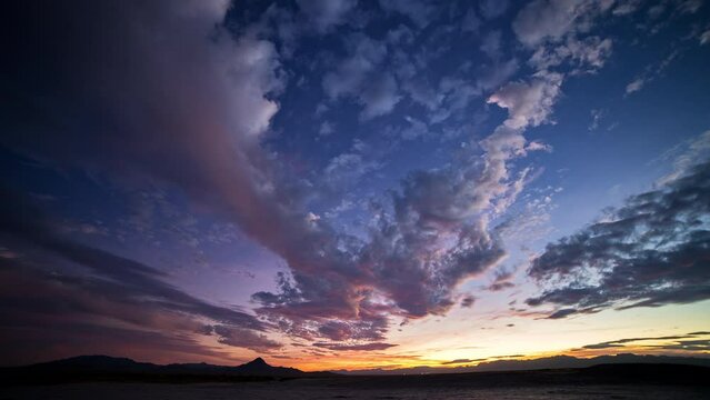 Holy Grail timelapse from day to night during colorful sunset over the Utah desert.