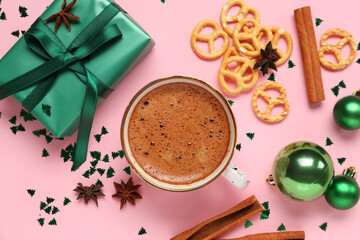 Beautiful composition with cup of coffee and Christmas decor on pink background