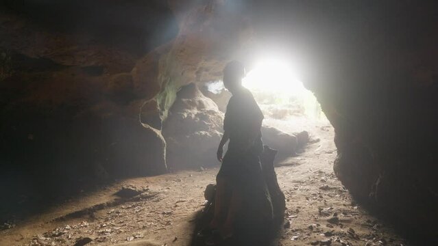 Mysterious figure Man smoking at the mouth of the cave, a blend of enigma and intrigue