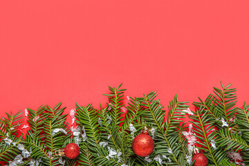 Composition with fir branches, Christmas balls and snow on red background