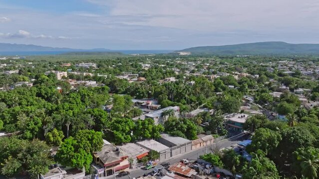 Aerial flyover Azua Village With green trees and old buildings on Dominican Republic at sunny day