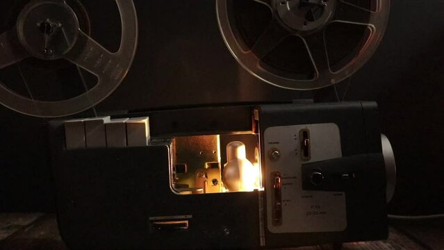cinema projector with film reels spinning