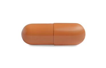 One brown pill on white background. Medicinal treatment