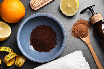 Flat lay composition with orange and ingredients for natural body scrub on grey table. Cellulite treatment