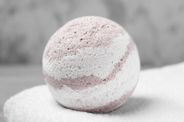 Bath bomb and towel on table, closeup