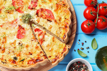 Tasty quiche with tomatoes, microgreens and cheese served on light blue wooden table, flat lay