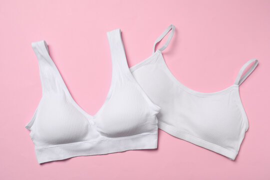 Stylish white women's underwear on pink background, flat lay