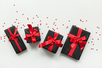 Many gift boxes and confetti on white background. Black Friday