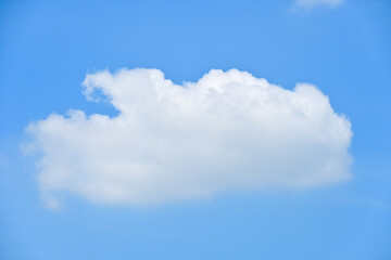 beautiful blue sky and white fluffy single cloud with sunrise in the morning, natural background