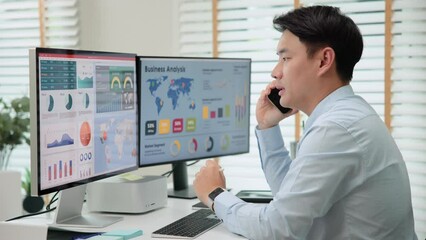 Asia people tech expert man phone call talking working on IT project predict sales SEO graph chart AI plan visual big data science report center BI smart tools screen. Office chinese asian analyst job - Powered by Adobe
