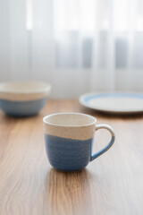 Vertical of vintage blue and white cup, tableware on wood table