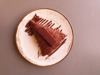 chocolate crepe with chocolate bar on plate