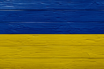 National flag of Ukraine painted on wooden surface