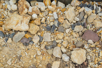 Texture of yellow crushed stone at construction site in summer. High quality photo